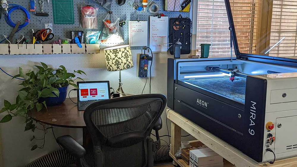 laser in a room with a round table, house plants, and bulletin board